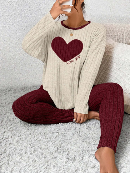 Plus size heart fitted loungewear featuring a cozy top with a heart graphic and matching pants, perfect for relaxation.