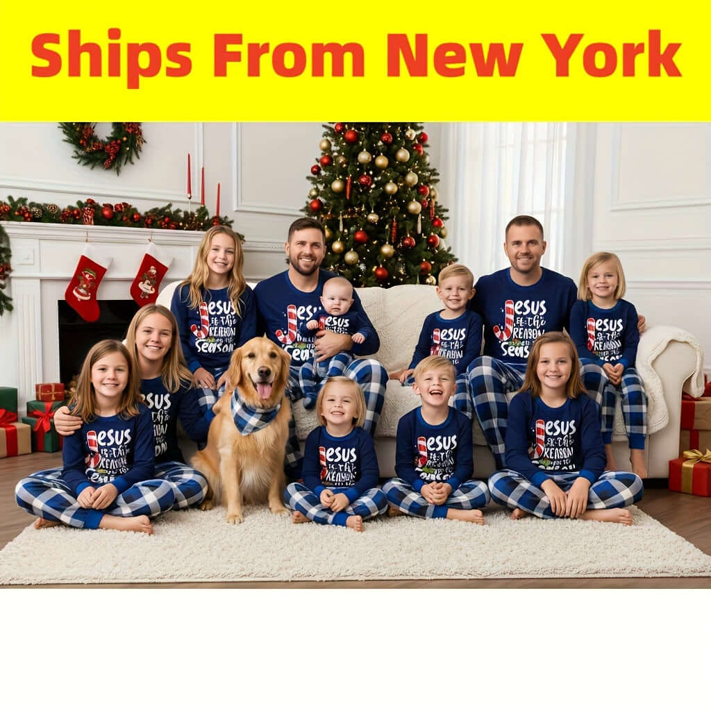 family matching Christmas pajamas with kids and adults sitting on couch with dog by Christmas tree