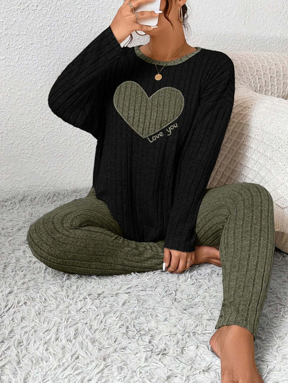 Model wearing plus size heart fitted loungewear featuring a heart design and relaxed fit on textured fabric.