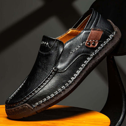 men's slip-on loafers in black leather with decorative stitching and brown accents, stylish footwear for casual occasions