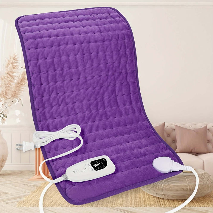 extra large electric heating pad in purple color with control unit and power cord on a cozy couch setting