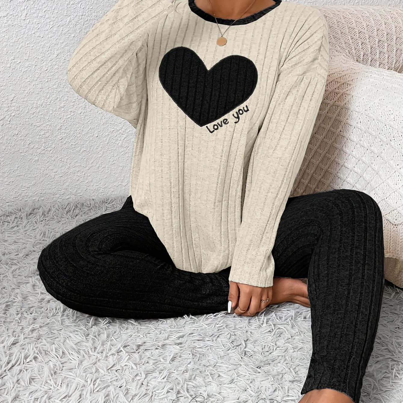 plus size heart fitted loungewear featuring a cozy ribbed top with a black heart and text design paired with black ribbed leggings.