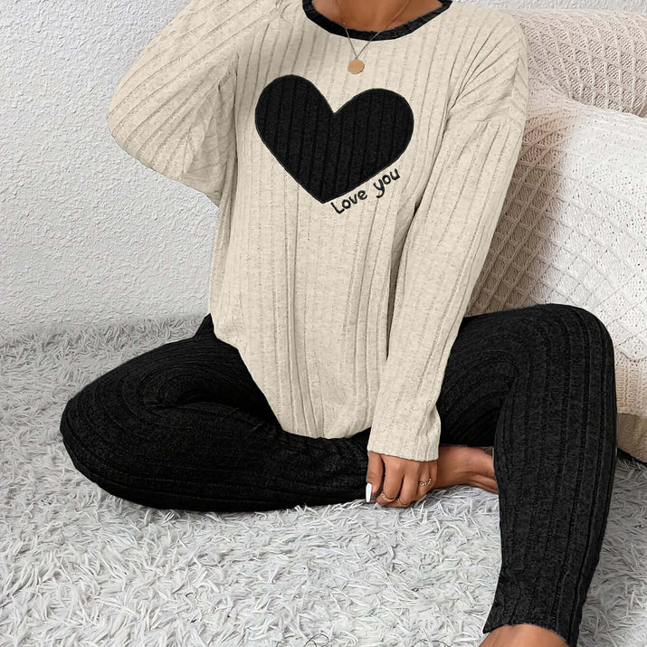 plus size heart fitted loungewear featuring a cozy ribbed top with a black heart and text design paired with black ribbed leggings.