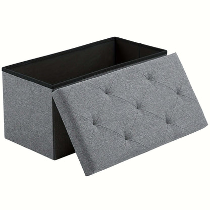 storage ottoman bench with a tufted gray fabric design and an open lid for storage.