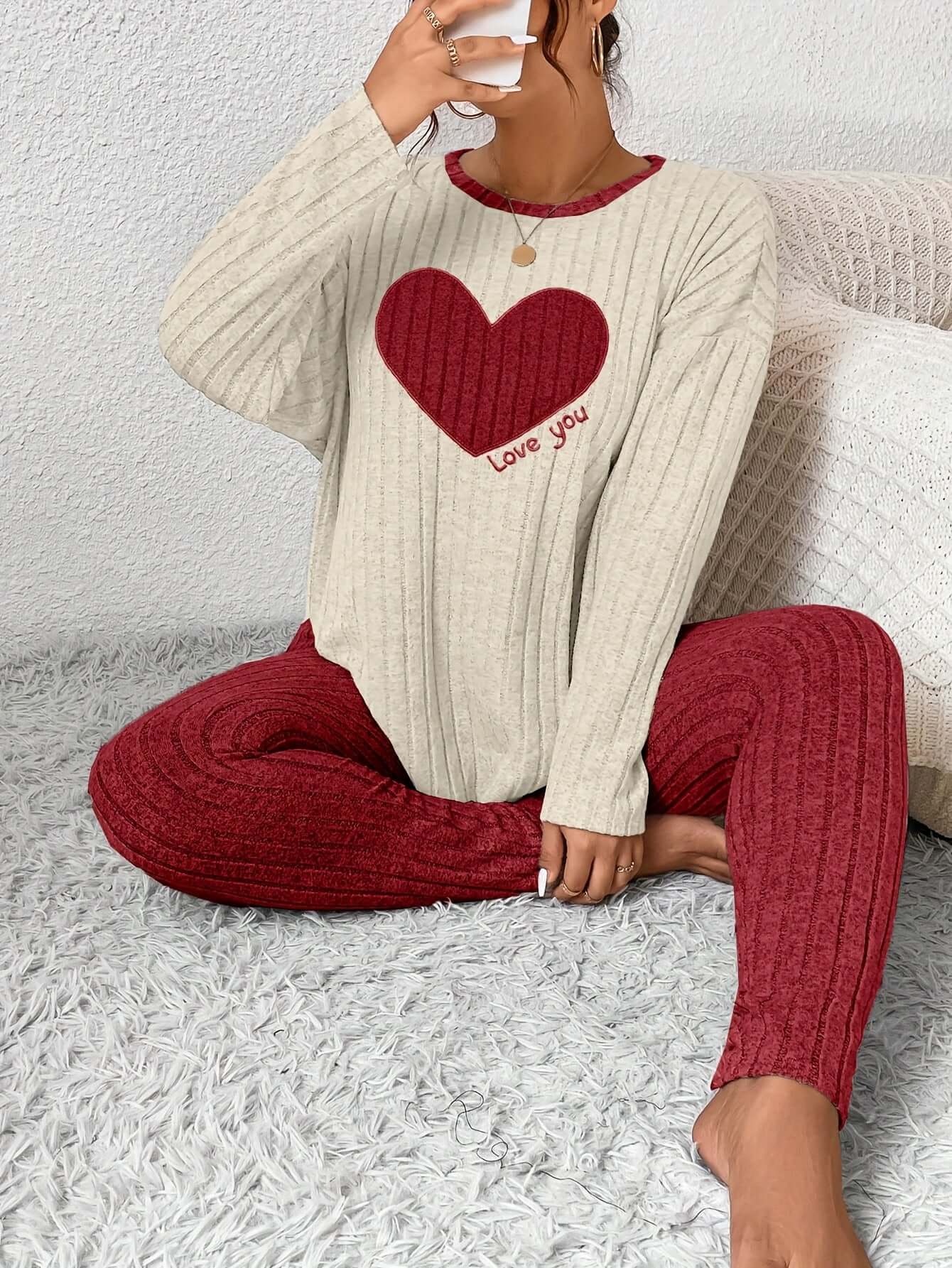 Model wearing plus size heart fitted loungewear featuring a red heart design and comfortable ribbed fabric.