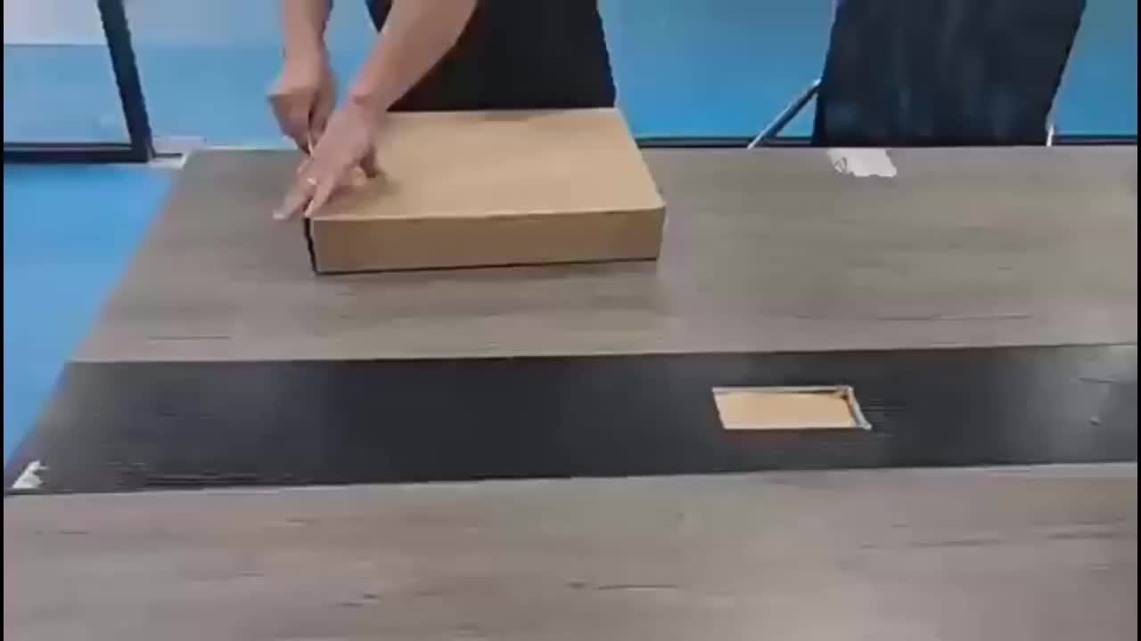 Person preparing to pack underbed storage bins with wheels on a wooden table