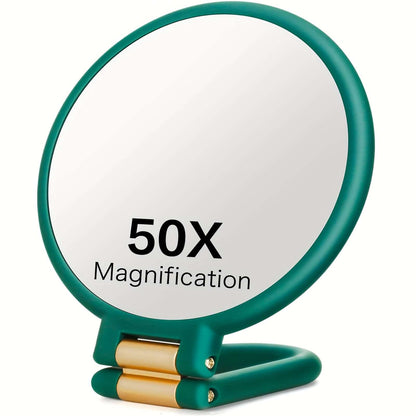 50x magnifying handheld mirror with green frame and gold hinge, showcasing 50X magnification for detailed viewing.