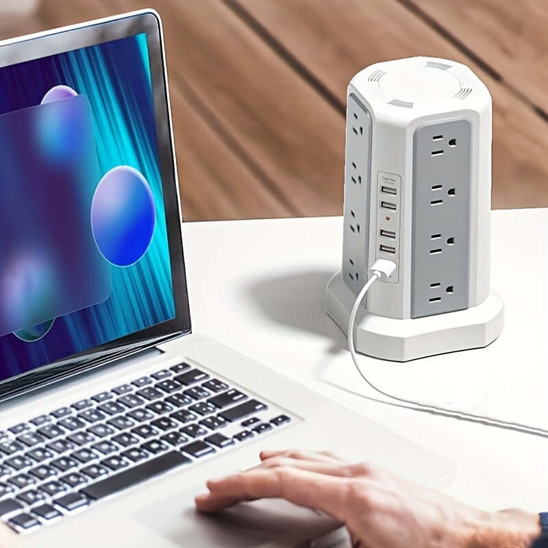 flat plug power board with USB ports connected to a laptop on a desk, showcasing multiple outlets and USB options.