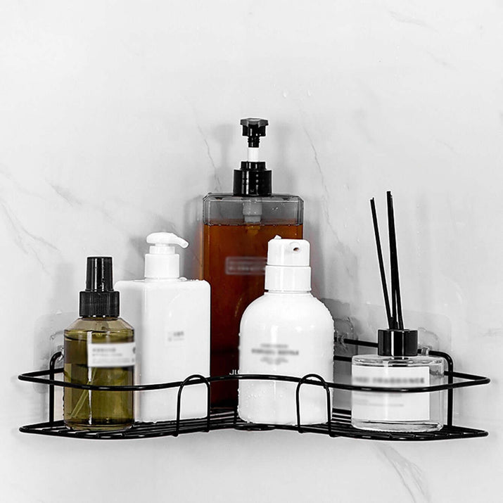 cast iron shower shelf holding various bottles and containers for bathroom organization