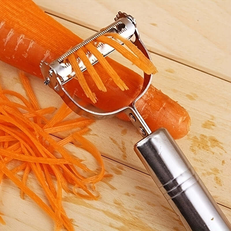 Stainless steel restaurant cookware tools, including a peeler slicing fresh carrots on a wooden surface.