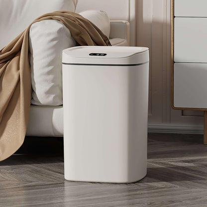 motion-sensor trash can specifications with sleek design beside a cozy couch and a blanket.