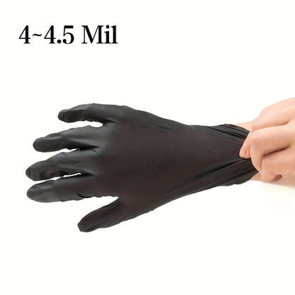 Person putting on disposable nitrile gloves for safety, 4~4.5 Mil thickness, providing protection and comfort.