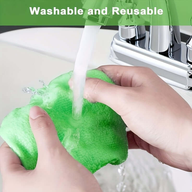 Hands washing a green microfiber cloth under running water, showcasing the benefits of a car window cleaning brush kit.