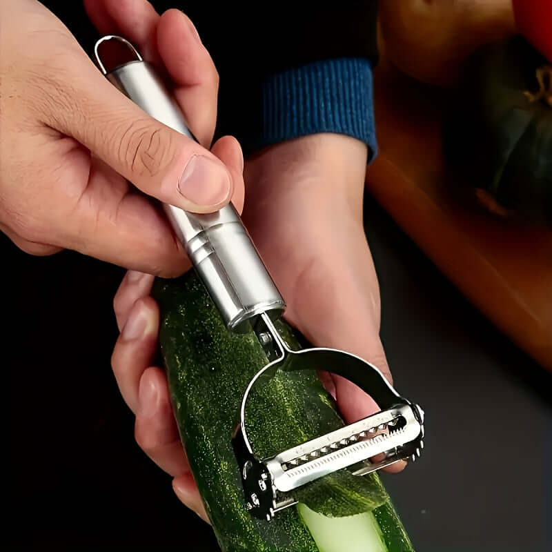 Person using stainless steel restaurant cookware for peeling a cucumber.
