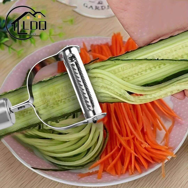 A hand using a stainless steel restaurant cookware peeler on cucumber, with carrot strips in the background.