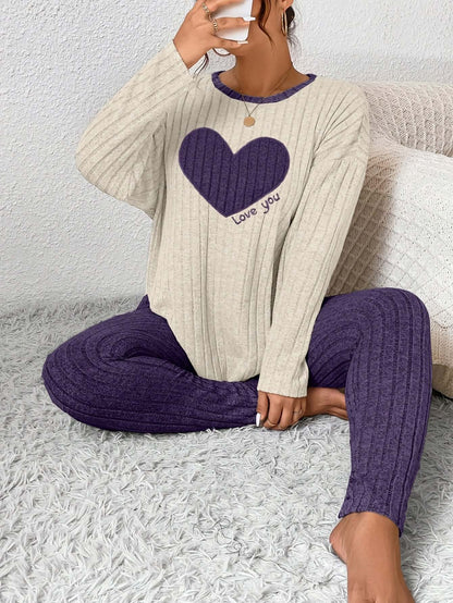 Woman relaxing in plus size heart fitted loungewear with a cozy heart graphic, perfect for casual comfort.