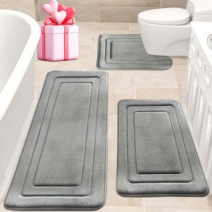 memory foam bath mat set placed in a bathroom with a bathtub and toilet, non-slip design in gray color.