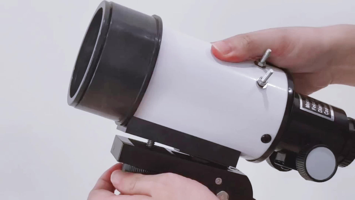 Hand adjusting the portable 150X telescope with tripod for optimal viewing.