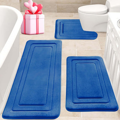 memory foam bath mat set in blue color placed on bathroom floor near toilet and bathtub.