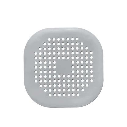 Silicone drain protector for bathroom kitchen, gray circular design with holes for effective drainage.