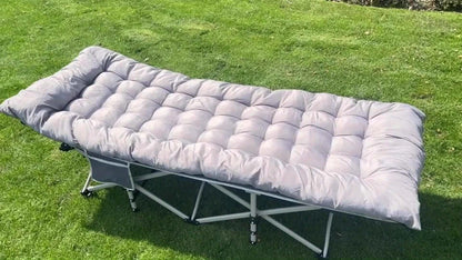 Portable folding guest bed set up on green grass, perfect for extra sleeping space for guests.