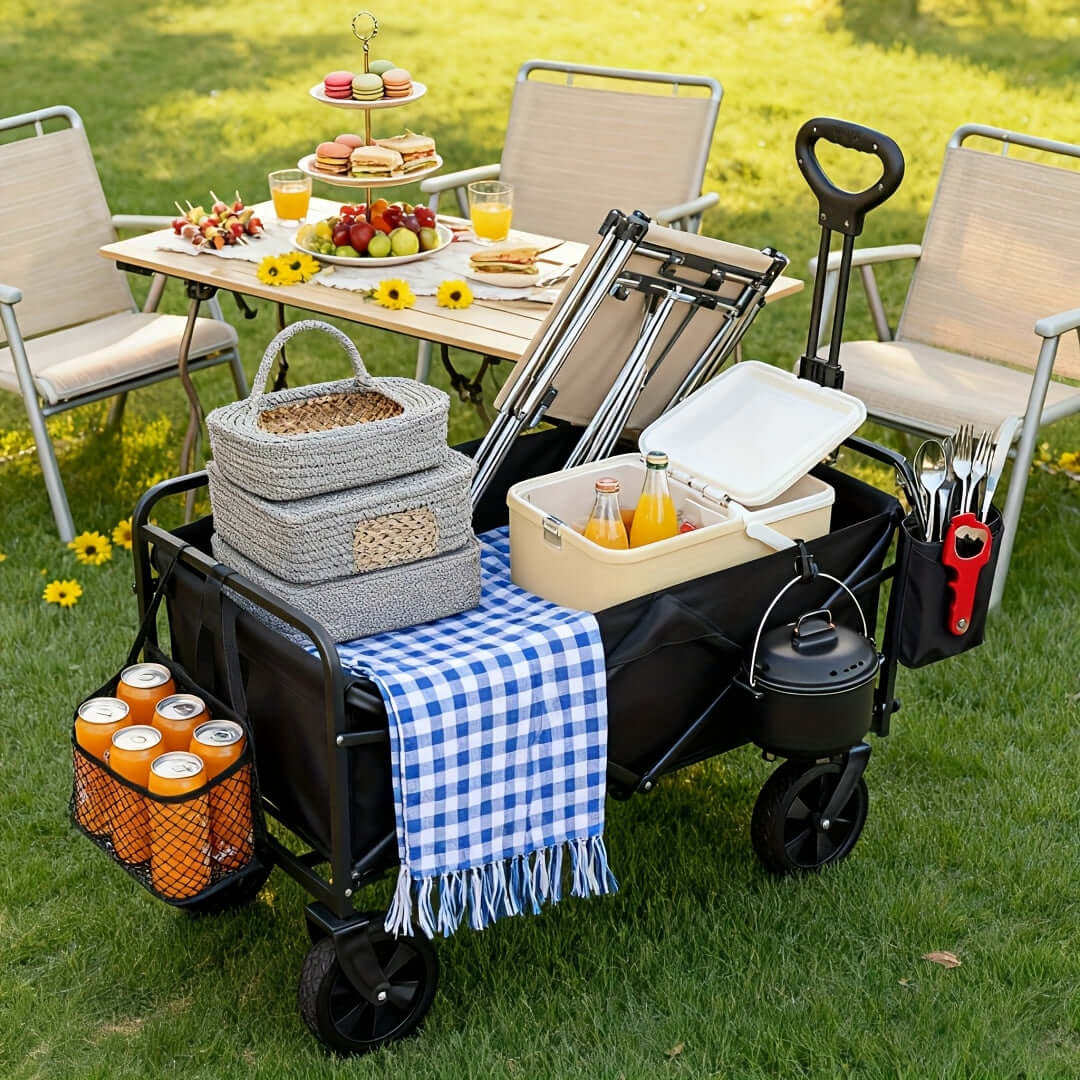 heavy duty folding cart for outdoor use filled with picnic supplies on a grassy area.