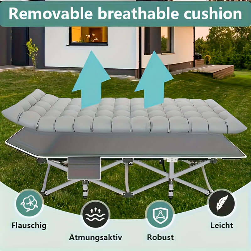 Portable folding guest bed with removable breathable cushion in a backyard setting.